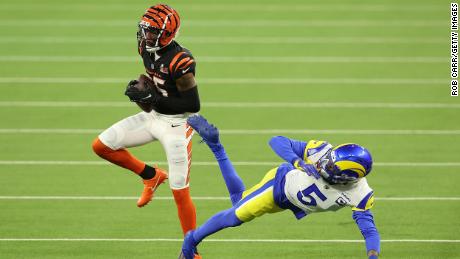 Cincinnati Bengals receiver T. Higgins holds the ball over Los Angeles Rams defensive linebacker Galen Ramsey to touch down in the third quarter of the Super Bowl LVI. 