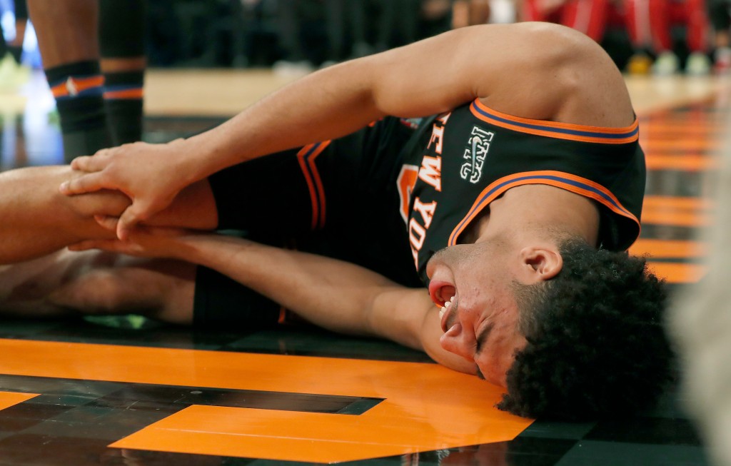 Quentin Grimes grabs his right knee.