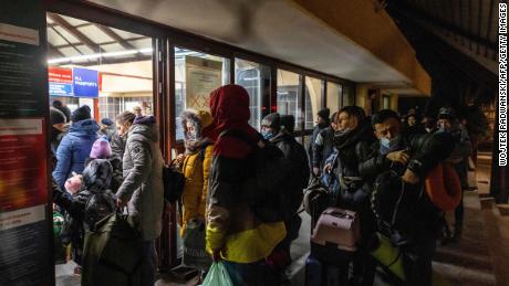 Ukrainian citizens arrive at a border checkpoint between Poland and Ukraine, during the early hours of February 26.