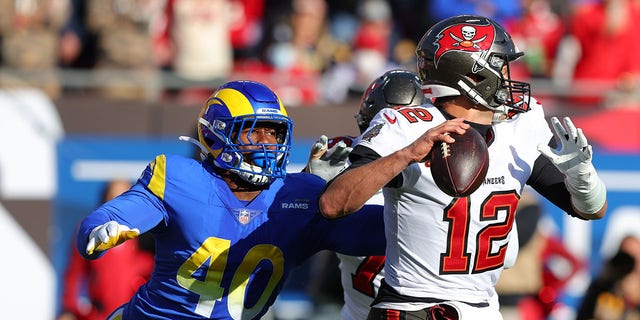 Tom Brady of the Tampa Bay Buccaneers looks to throw the ball as Von Miller of the Los Angeles Rams defends in the second quarter in the NFC Divisions Playoff game at Raymond James Stadium on January 23, 2022 in Tampa, Florida. 