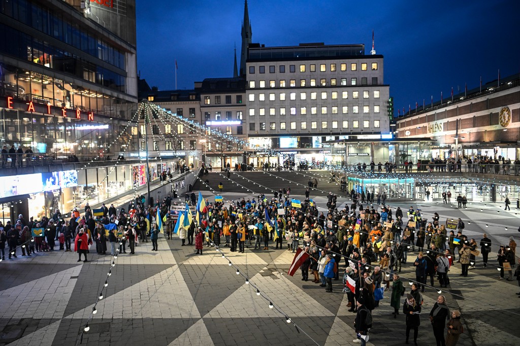 Demonstrators hold Ukrainian flags and anti-war banners during a demonstration in Stockholm, Sweden. 