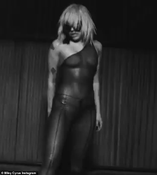 Cyrus looked decent in a sheer suit that she wore in a black and white clip
