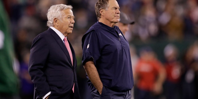 Robert Kraft, owner of the New England Patriots, left, talks with coach Bill Belichick as their team prepares before an NFL football game against the New York Jets in East Rutherford, New Jersey, on Oct. 21, 2019, file photo.