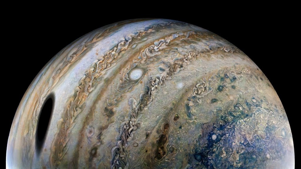 Ganymede casts a massive shadow across Jupiter in a stunning new image from NASA's Juno spacecraft