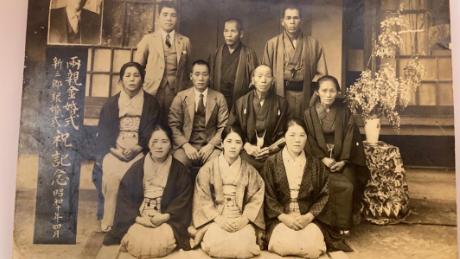 The photo shows Ken Tanaka, age 32 in 1935, in the middle of the front row.