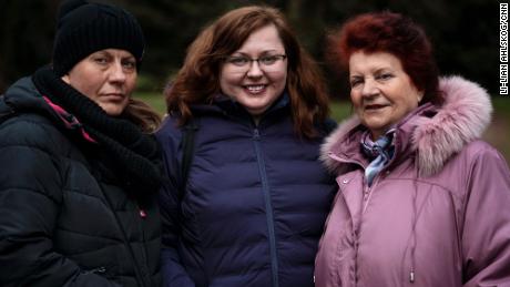 Mila Turchin (center) is finally reunited with her mother Luba (right) and sister Vita (left) in Poland after a harrowing journey.