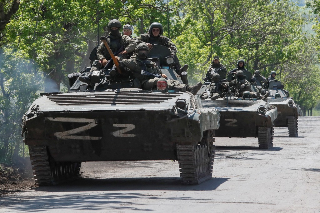A convoy of Russian armored vehicles drives along a road in the context of the Ukrainian-Russian conflict near Mariupol on May 20. 