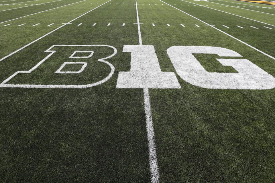FILE - The Big Ten logo is displayed on the field before the NCAA college football game between Iowa and Miami, Ohio in Iowa City, Iowa, August 31, 2019. History and tradition?  Those terms carry no weight in what has essentially become a game of risk taking, with the Big Ten and Southeastern Conference taking turns rolling dice to determine how to divide the world of college football.  (AP Photo/Charlie Neibergall, File)