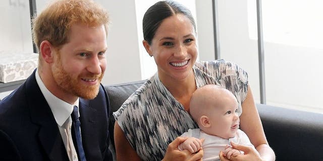 Harry and Meghan sit with their son Archie during their tour of Cape Town, South Africa. 