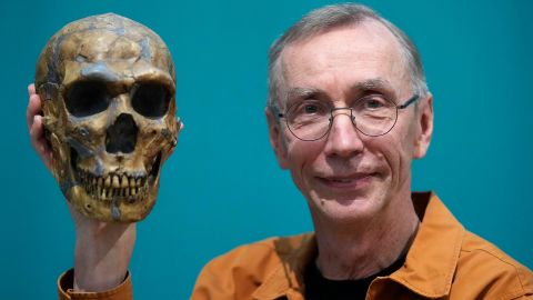 Swedish scientist Svante Pääbo displays a replica of a Neanderthal skeleton.
