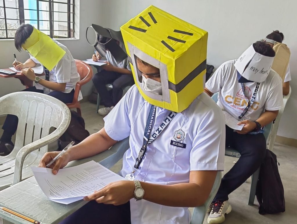 There are pictures of Filipino students wearing anti-cheating hats
