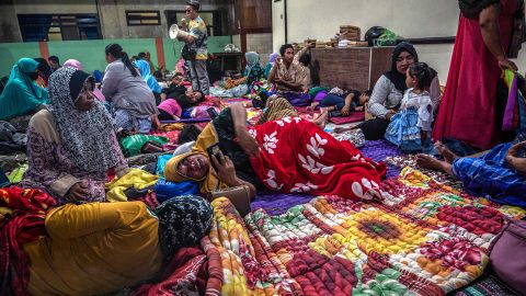 People take shelter in a community hall in Kandipuru village after the eruption of Mount Semeru volcano in Lumagang, East Java on December 4, 2022.